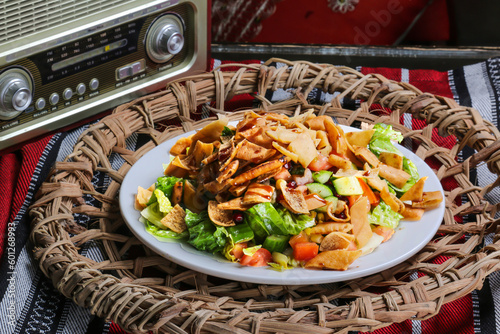 Fatoosh, fatoosh salad with crackers, cucumber, tomato, onion served in dish isolated on red mat top view on table arabic food photo