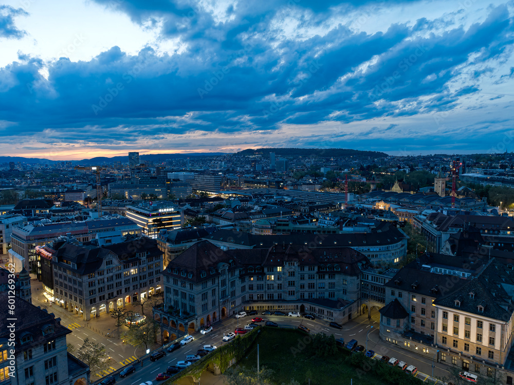 Aerial view over City of Zürich with skyline and main police station the foreground on a cloudy spring evening. Movie shot May 6th, 2023, Zurich, Switzerland.