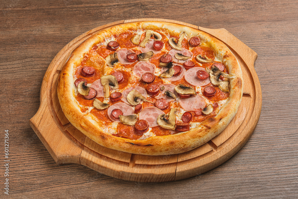 Fresh classic pizza with tomato sauce, mozzarella, spicy chorizo, bell pepper on a wooden background