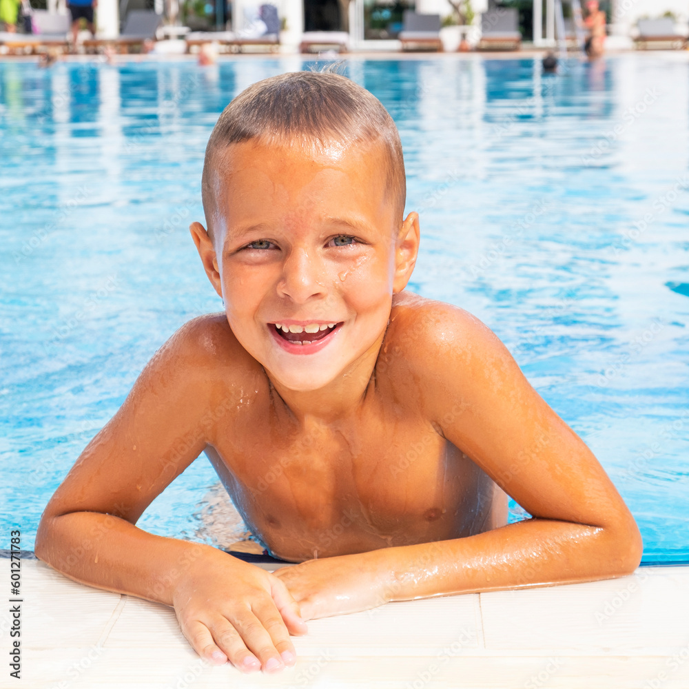 Smiling boy in a swimming pool. Summer vacation concept. 