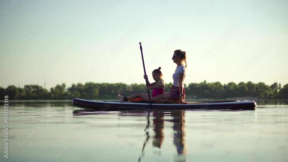 family using an inflatable board for rowing family using an inflatable board for rowing