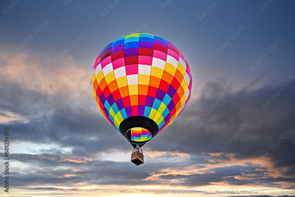 Fototapeta premium Colorful hot air balloon flying at sunset