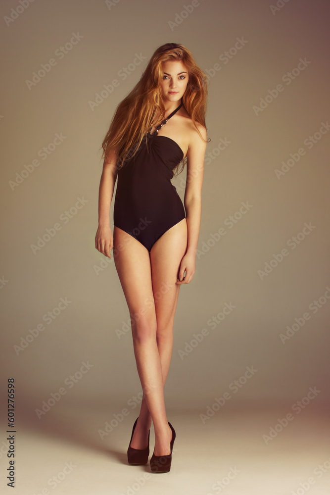 Fashion, portrait and girl in swimsuit in studio for clothing, confidence or attitude on wall background. Full body, swimsuit and gen z female model pose with body, shape or summer aesthetic isolated