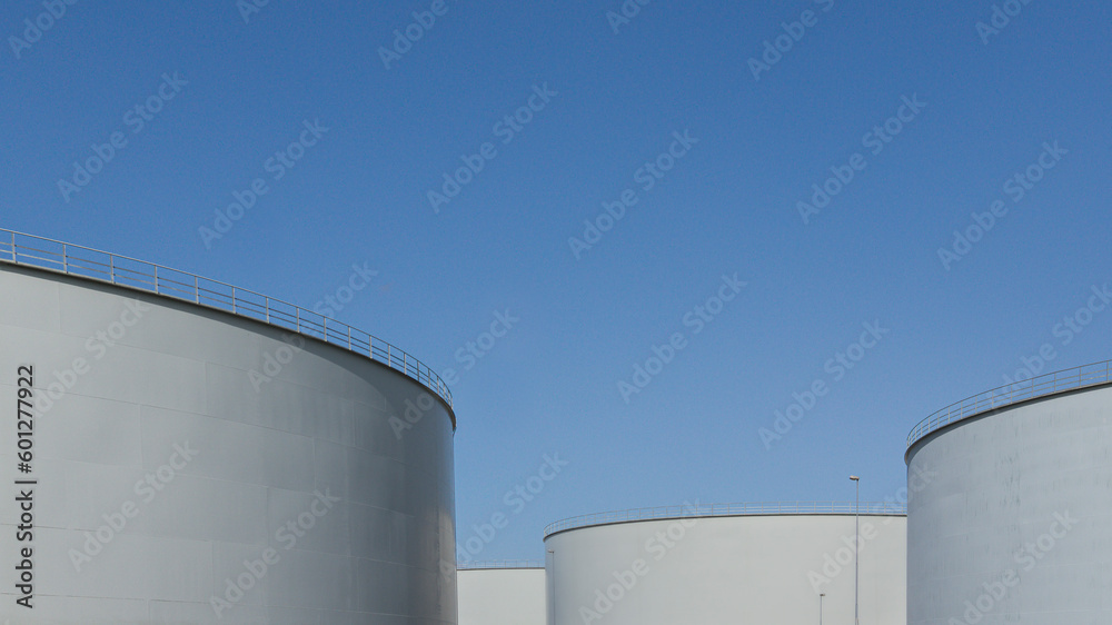 three large oil tanks against the blue sky with space for text three large oil tanks against the blue sky with space for text