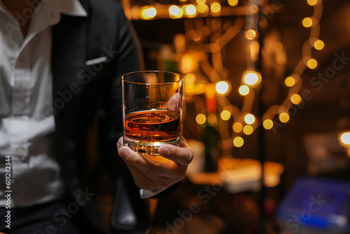 Closeup businessmen holding a glass of whiskey