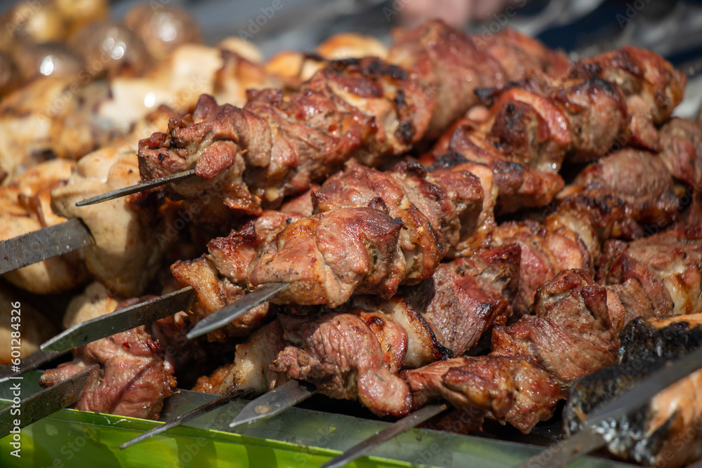 Grilled meat on skewers, barbecue on coals.