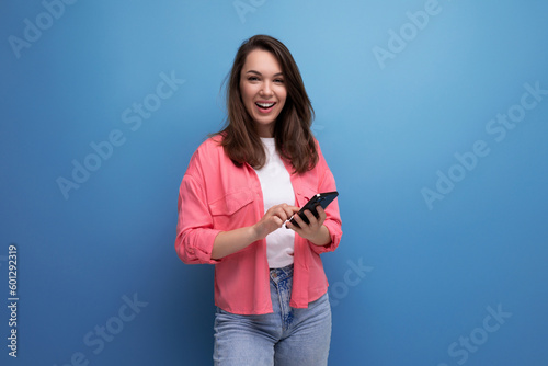 portrait of stylish dark haired young woman with hollywood smile isolated with studio background © Ivan Traimak