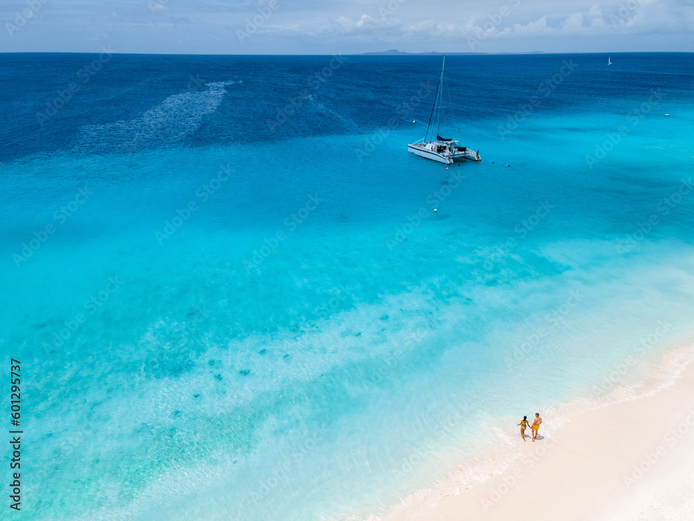 Drone aerial view at Klein Curacao Island with Tropical beach at the Caribbean, a couple of men and women on a boat trip to Small Curacao Island