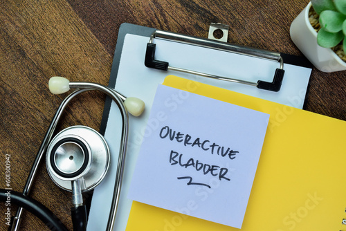 Concept of Overactive Bladder write on sticky notes with stethoscope isolated on Wooden Table. photo