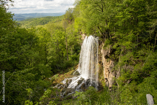 Falling Spring Falls in Summer with Mountains and Sky