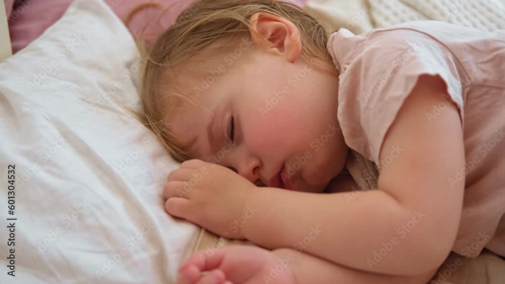 Peaceful adorable baby sleeping on his bed at home. Sleeping newborn baby concept. One year old baby girl sleeps peaceful at domestic room interior background. Serene dream. Cute Face Close Up. Peaceful adorable baby sleeping on his bed at home. Sleeping newborn baby concept. One year old baby girl sleeps peaceful at domestic room interior background. Serene dream. Cute Face Close Up.