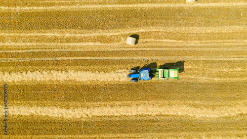 Photos Aerial view of tractor tow trailed bale machine to collect straw from harvested