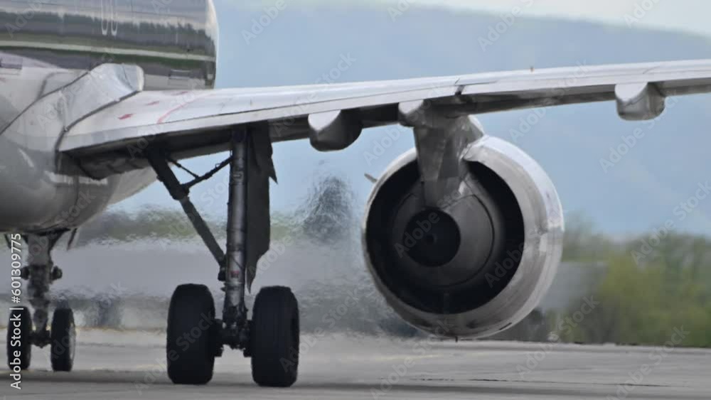Huge airplane jet engine close up view moving forward heat haze distant airplane lining up behind. 4k super slow motion raw video 120 fps