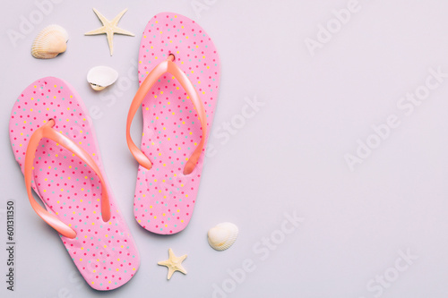 Flat lay composition with flip flops and seashell on colored background. Space for text top view