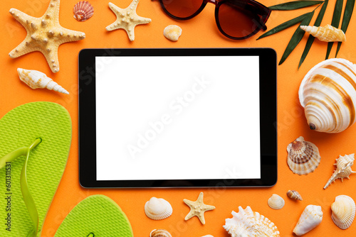 Flat lay composition with tablet and beach accessories on colored background. Tablet computer with blank screen mock up with copy space