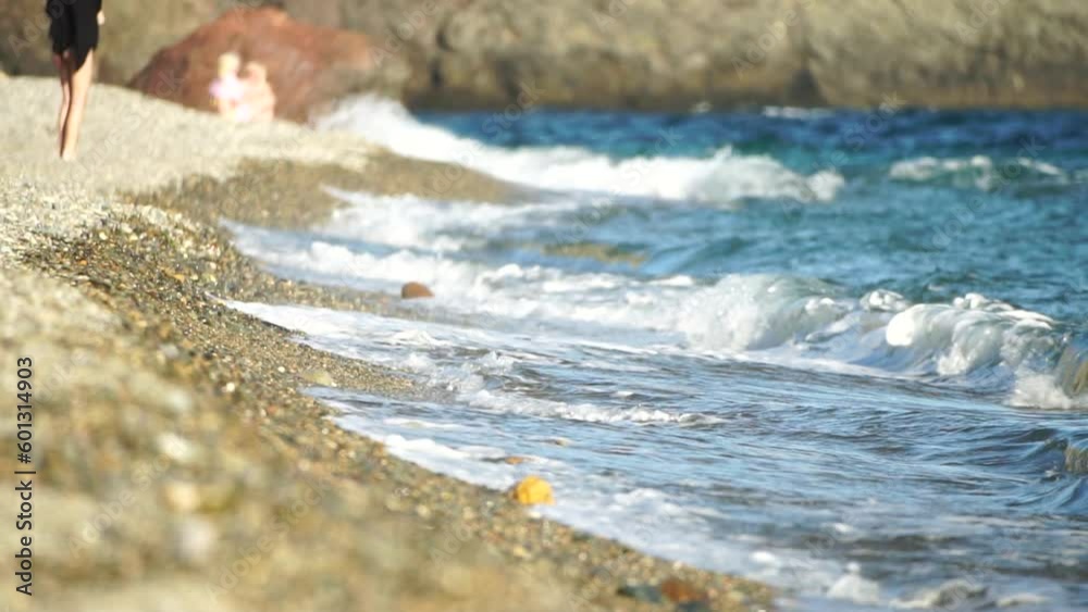 Small sea wave, Blurred Soft foamy waves washing golden pebbled beach on sunset. Ocean Waves On Beach. Nobody. Holiday recreation concept. Abstract nautical summer ocean sunset nature background. Small sea wave, Blurred Soft foamy waves washing golden pebbled beach on sunset. Ocean Waves On Beach. Nobody. Holiday recreation concept. Abstract nautical summer ocean sunset nature background.