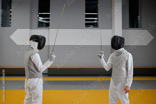 Cuadro en lienzo Two fencers staying with raised rapiers front of each other ready to fight
