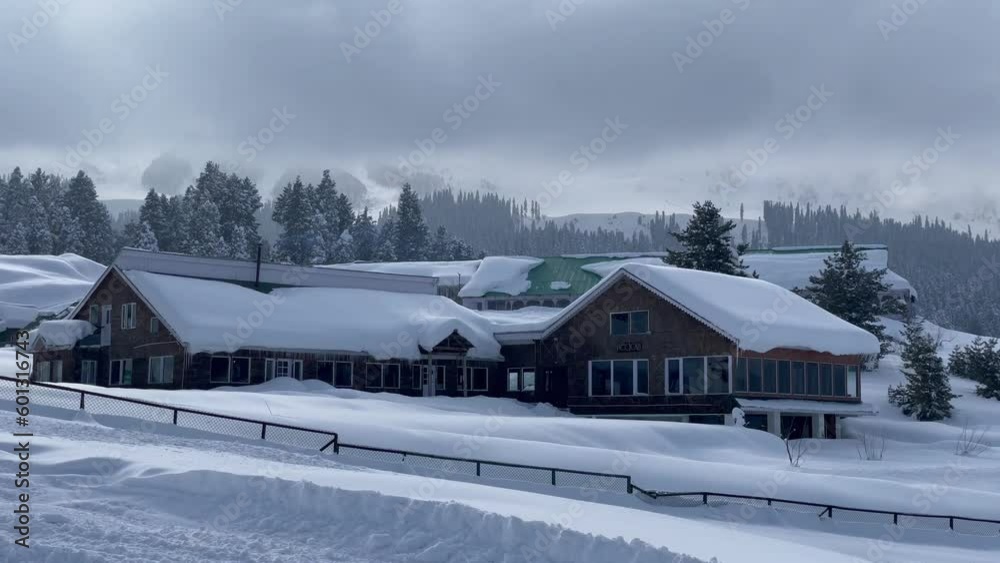 Dramatic Sky Over Lodges Covered In Snow On The Wintry Mountain In Gulmarg, India. pan right Dramatic Sky Over Lodges Covered In Snow On The Wintry Mountain In Gulmarg, India. pan right