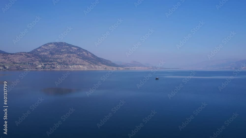 Drone flying over Okanagan Lake with boat driving towards a Penticton harbor. Drone flying over Okanagan Lake with boat driving towards a Penticton harbor.