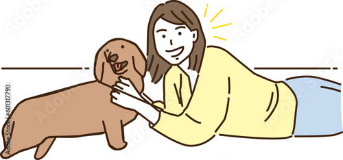 愛犬と寝転ぶ若い女性
