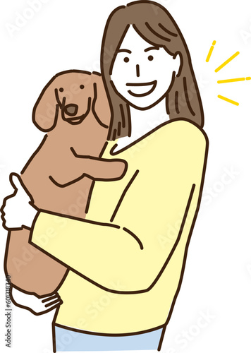 愛犬を抱っこする若い女性
