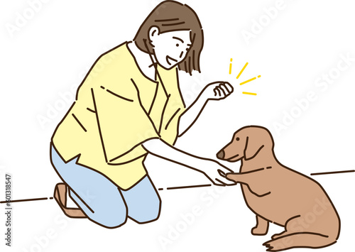 愛犬の躾をする若い女性