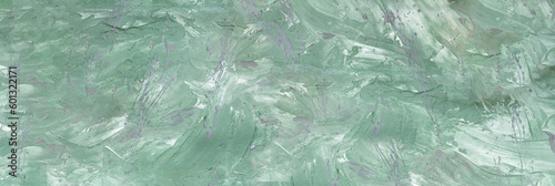 Green background with dynamic paint strokes and malachite splashes. Spring or summer background. Drawn. Copy space