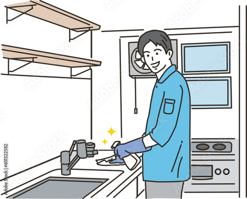 キッチンの掃除をする清掃業の若い男性
