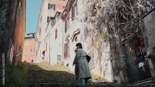 Beautiful young female walking in old town streets and stairways 