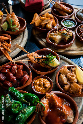 Tapas Bowls with Food arranged on a Table in a Tapas Bar.