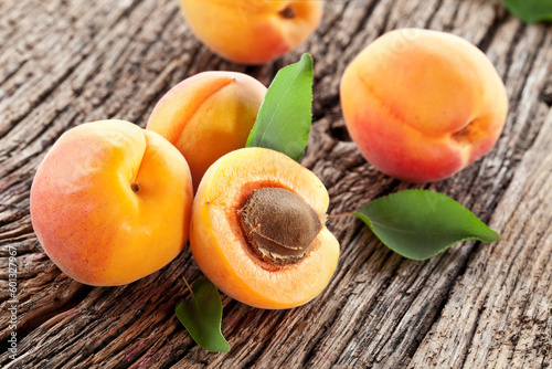 Ripe apricots on old wooden table.