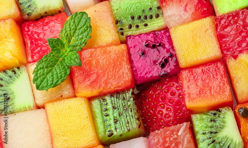 Fruit puzzle. Colorful food background or pattern arranged of different fruit cubes. Dietary concept.