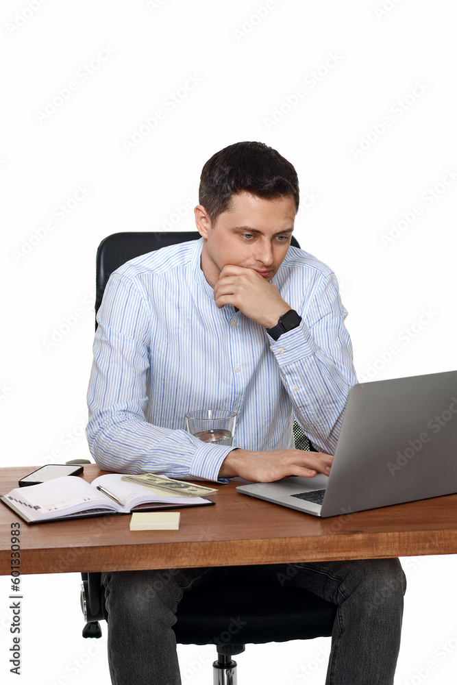 young man using laptop computer for online work at table young man using laptop computer for online work at table