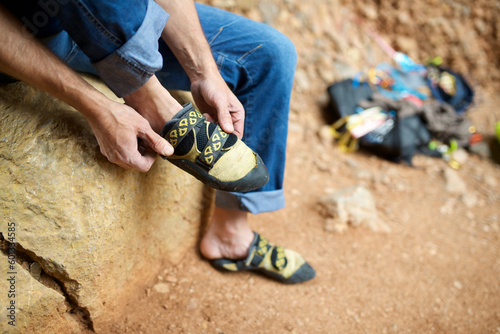 Climber putting on his climbing shoes in the Mallos de Riglos in Spain. photo