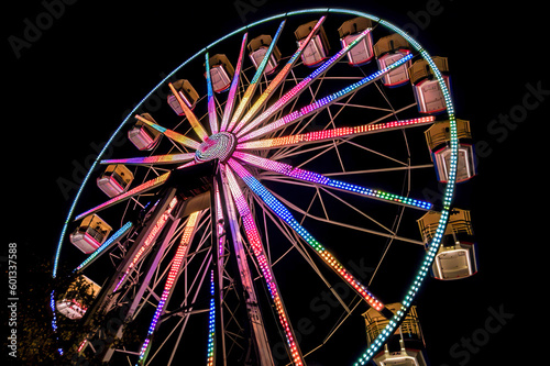 Nighttime Thrills: The Mesmerizing Beauty of a Ferris Wheel Illuminated Against the City Skyline, ai generative