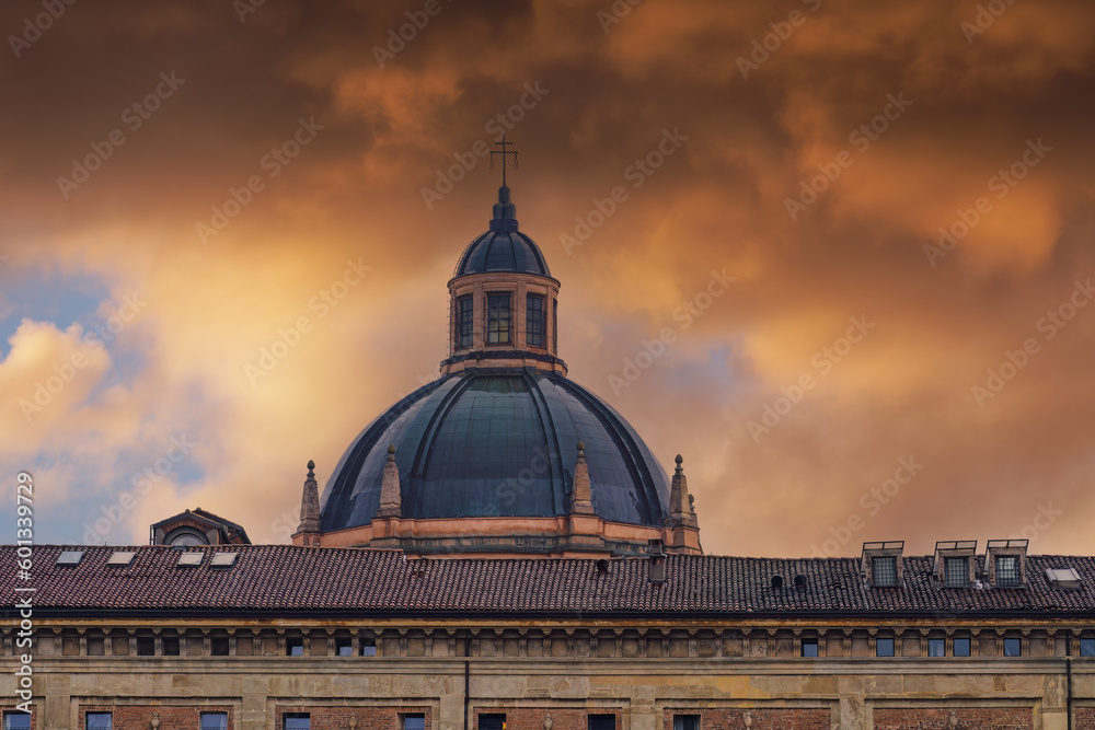Bologna, Italy Santa Maria della Vita Catholic church dome against dramatic orange clouds.