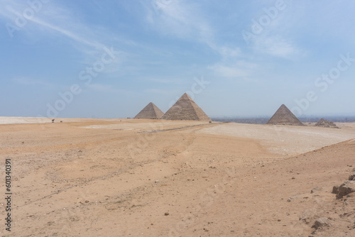 Sahara Desert with the Three pyramids of Giza  the Great Pyramid  Pyramid of Khafre and Pyramid of Menkaure  Cairo City in the background.