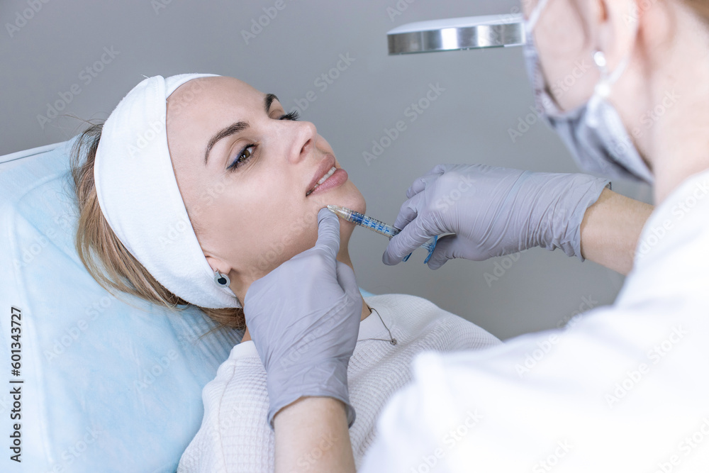 A cosmetologist in medical gloves fills women's wrinkles with hyaluronic acid A cosmetologist in medical gloves fills women's wrinkles with hyaluronic acid