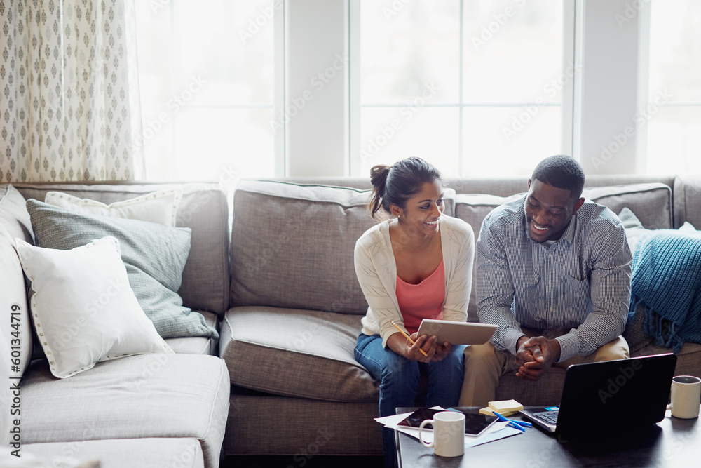 Happy couple, paperwork and on the sofa together or using laptop for bills or invoice and notebook for tax at home. Accounting, young family and on laptop or couch in the house or mortgage documents Happy couple, paperwork and on the sofa together or using laptop for bills or invoice and notebook for tax at home. Accounting, young family and on laptop or couch in the house or mortgage documents
