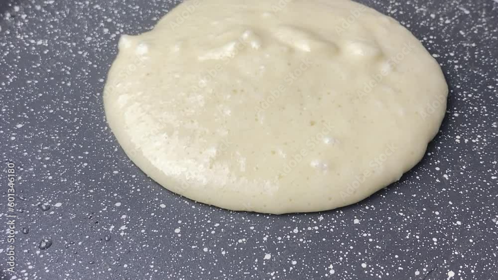 Cooking pancake in a hot pan. Close up shot of woman hand using spatula flipping pancake in hot frying pan Making pancake homemade recipe pancake for family delicious breakfast meal. Cooking pancake in a hot pan. Close up shot of woman hand using spatula flipping pancake in hot frying pan Making pancake homemade recipe pancake for family delicious breakfast meal.