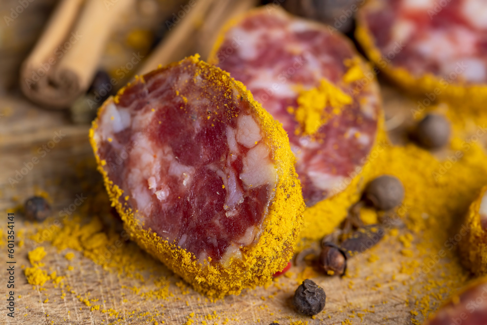 Sliced veal salami with turmeric