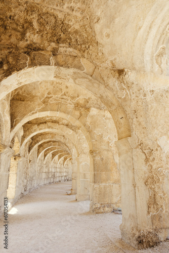 A photo of the upper balcony walkway and arches in Aspendos ancient theater, emphasizing its architectural beauty and scale. © gokcen