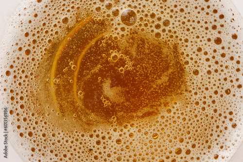 Beer foam and bubbles close-up in a glass, macro