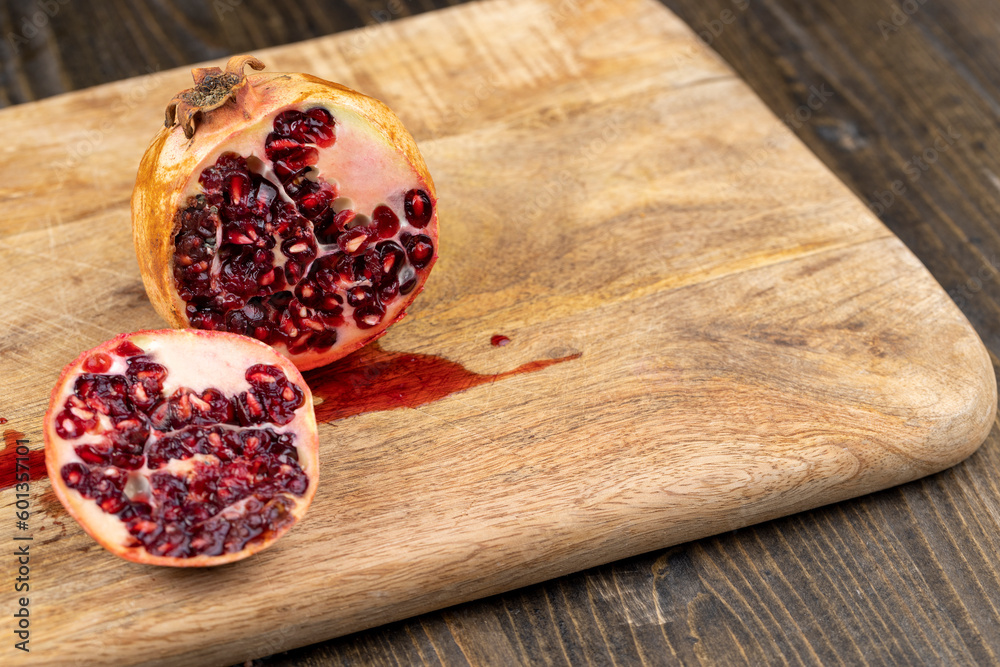 Half-cut ripe red pomegranate with mold Half-cut ripe red pomegranate with mold