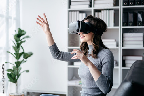 Businesswoman with vr headset lifestyle concept, Businesswoman wearing VR headset to playing game and touching in the air for experience virtual reality while relaxation with technology after working