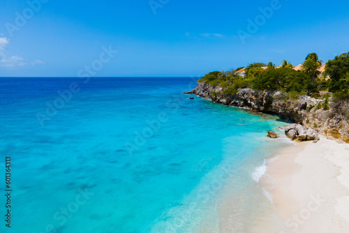 Playa Kalki Beach Caribbean island of Curacao, Playa Kalki in Curacao, white beach with a blue turqouse colored ocean. Drone aerial view above a beach with beach chairs and umbrellas © Chirapriya
