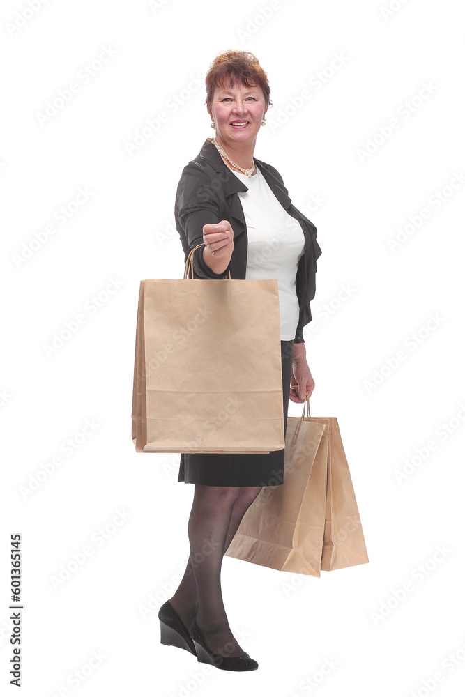 Side view portrait of happy senior woman posing with her shopping bag Side view portrait of happy senior woman posing with her shopping bag