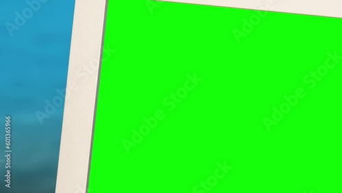 White photo frame standing on the beach by the sea. Green screen.