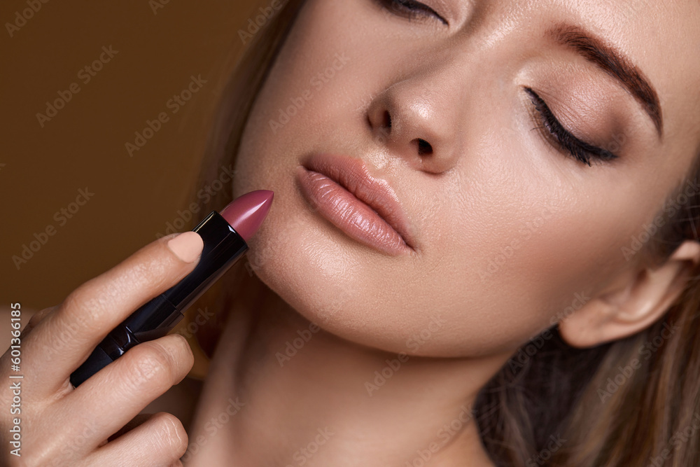 beautiful young smiling woman holding nude pink lipstick beautiful young smiling woman holding nude pink lipstick