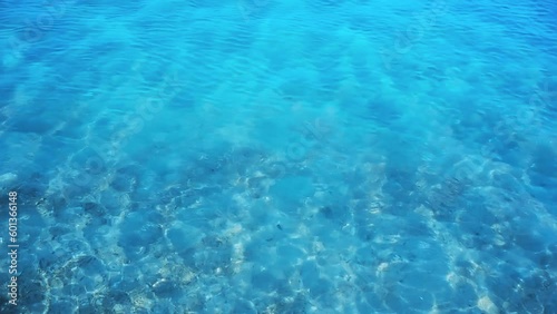 Beach Sand Seashore with blue wave and white sparkling summer background, top view overhead seashore.